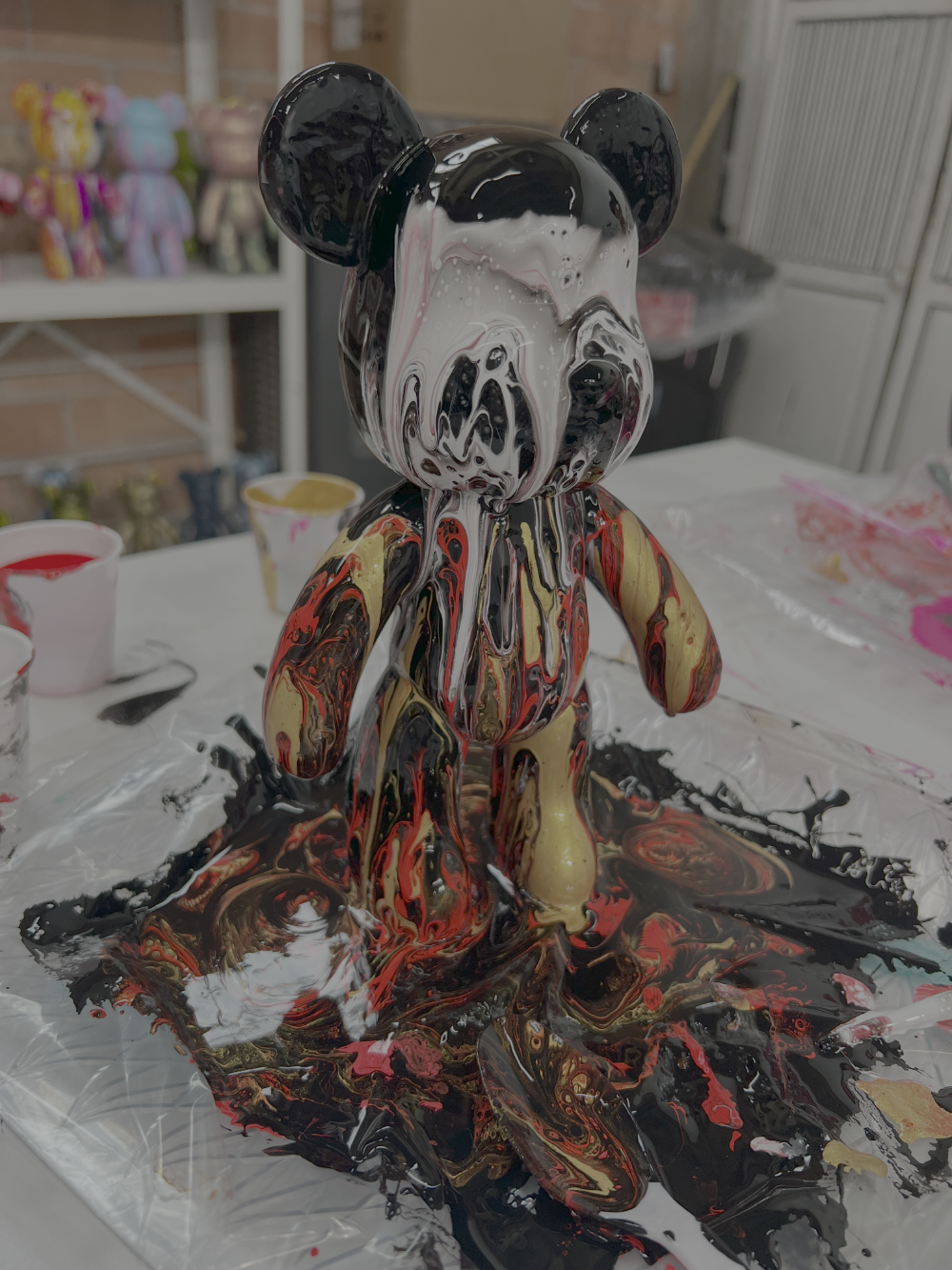 Black, white, red, and gold fluid-painted bear