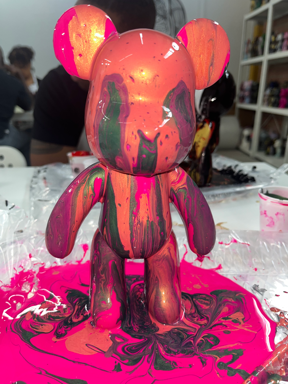 Pink, orange, and green fluid-painted bear