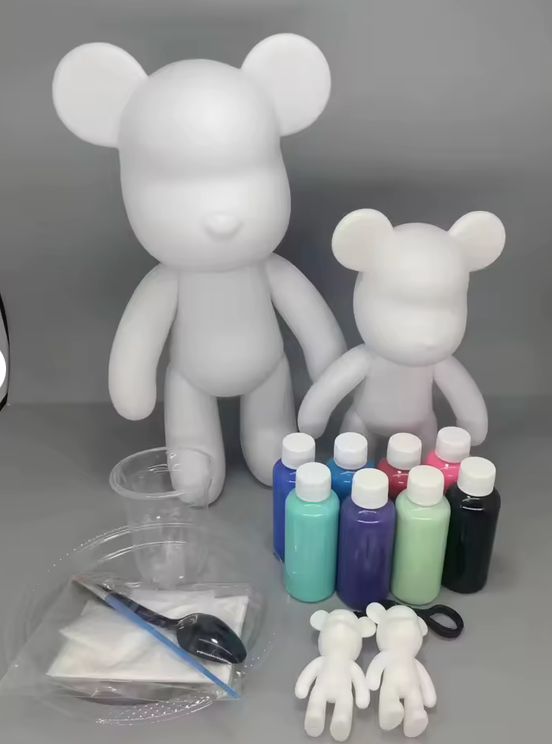 Blank bear forms with paint bottles and supplies
